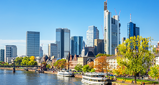 In Frankfurt varen boten op de Main-rivier voor de skyline.
